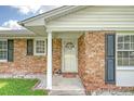 Home exterior featuring a classic brick facade, white door, and manicured lawn at 113 Jackson Rd, Ladson, SC 29456