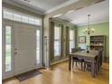 Open floor plan featuring a dining room with an elegant chandelier and hardwood floors at 1213 Grasswind Dr, Hanahan, SC 29410