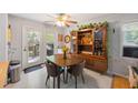 Cozy dining area with natural light, a wooden table set, and a display cabinet decorated with plants at 124 Englewood Rd, Goose Creek, SC 29445