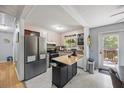 Bright kitchen featuring stainless steel appliances, light cabinets, and a functional kitchen island at 124 Englewood Rd, Goose Creek, SC 29445