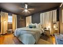 Stylish main bedroom with dark walls, modern ceiling fan, plush bedding, and ambient lighting at 124 Englewood Rd, Goose Creek, SC 29445