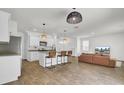 Open-concept living space with a kitchen island, a dining area, and a comfortable living room with a sofa at 138 Sweet Cherry Ln, Summerville, SC 29486
