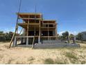 Exterior shot of a multi-story home under construction on a sandy lot with scaffolding at 2879 Marshall Blvd, Sullivans Island, SC 29482
