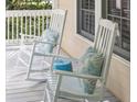 Relaxing porch scene with white rocking chairs and decorative pillows, perfect for enjoying the outdoors at 2911 Old Tavern Ct, Mount Pleasant, SC 29466