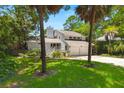 Charming two-story home with a two-car garage, surrounded by mature trees and lush greenery at 3 Sand Dollar Dr, Isle of Palms, SC 29451