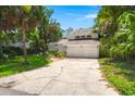 Inviting two-story home with a spacious driveway and mature landscaping at 3 Sand Dollar Dr, Isle of Palms, SC 29451