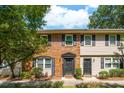 Inviting townhouse exterior featuring brick and siding, complemented by dark shutters at 415 Parkdale Drive # E-8, Charleston, SC 29414