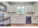 Bright kitchen with white cabinets, quartz countertops, and stainless steel appliances at 4847 Cane Pole Ln, Summerville, SC 29485