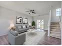 Bright living room with neutral walls, modern furniture, and access to a patio at 4847 Cane Pole Ln, Summerville, SC 29485