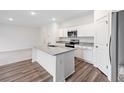Stylish kitchen with granite countertops, an island, stainless steel appliances, and hardwood floors at 5005 Ferry Field Dr, Summerville, SC 29485