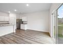 Bright open floorplan boasts hardwood floors and stainless steel appliances at 5005 Ferry Field Dr, Summerville, SC 29485
