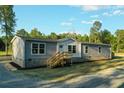 Charming home exterior with gray siding, white trim, and a wooden front porch at 526 Branch Bend Way, Cross, SC 29436