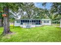 Charming single-story home with a screened porch and lush green lawn, perfect for relaxing outdoors at 538 Castlebury Rd, Walterboro, SC 29488