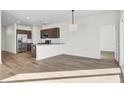 Open concept living room view of kitchen with hardwood floors and plenty of light at 545 Wayton Cir, Moncks Corner, SC 29461