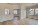Inviting foyer with light wood floors, white walls, and a view into the dining area and another room at 549 Verdi Dr, Summerville, SC 29486