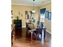 Elegant dining room featuring a dark wood table, decorative art, and sophisticated lighting at 620 Saint Ives Ln, Goose Creek, SC 29445