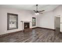 The living room features dark wood floors, a ceiling fan, two windows, and a brick fireplace at 8108 Halifax Way, North Charleston, SC 29420