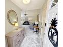 Welcoming entryway with stylish console, ornate mirror, and an open view into the comfortable living space beyond at 8496 Roanoke Dr, North Charleston, SC 29406