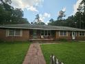 Brick home showcasing a brick walkway that leads to the covered entryway and front door at 8719 Jefferies Hwy, Walterboro, SC 29488
