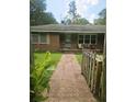 Brick home showing the walkway to the front door and partially obscured view at 8719 Jefferies Hwy, Walterboro, SC 29488