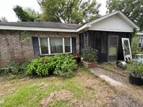 Brick ranch house with screened porch, needs landscaping at 1908 Savage Rd, Charleston, SC 29407