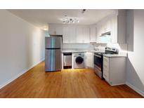 Modern kitchen with stainless steel appliances and wood flooring at 40 Bee St # 111, Charleston, SC 29403