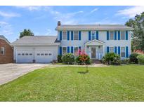 Two-story house with blue shutters, attached garage, and well-manicured lawn at 13 Charlyn Dr, Charleston, SC 29407