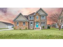 Two-story house with stone accents and a teal front door at 1713 Pimlico Blvd, Moncks Corner, SC 29461