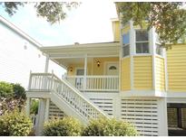 Yellow house exterior with white trim, deck, and stairs at 2 Pelican Reach # Share 10, Isle of Palms, SC 29451