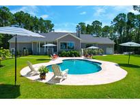 Inviting kidney-shaped pool with surrounding patio at 769 Bulls Bay Blvd, Awendaw, SC 29429