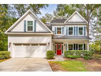 Charming two-story home featuring a bright red front door, blue shutters, and a well-manicured lawn at 1532 Joe Rouse Rd, Mount Pleasant, SC 29466