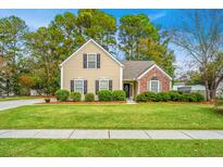 Charming home featuring a combination of tan siding and brick, complemented by well-maintained landscaping at 177 Thousand Oaks Cir, Goose Creek, SC 29445