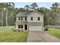 Two-story house with attached garage and landscaped lawn at 1625 Pimlico Blvd, Moncks Corner, SC 29461