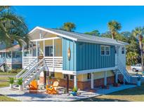 Charming beach cottage with a spacious porch and a fenced yard at 316 W Cooper Ave, Folly Beach, SC 29439