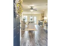 Open concept living space with hardwood floors, leading to dining and living areas at 1005 Washitonia # C, Charleston, SC 29492