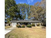 Ranch-style brick home with a spacious yard and mature trees at 112 Beatrice Ln, Summerville, SC 29485