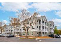 Three-story apartment building with balconies and ample parking at 130 River Landing Dr # 8203, Charleston, SC 29492