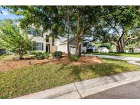 Two-story house with beige siding, landscaping, and a large driveway at 1330 Somersby Ln, Mount Pleasant, SC 29466