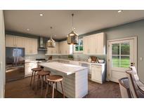 Modern kitchen with island, stainless steel appliances, and white cabinets at 524 Hayes Park Blvd # 3, Johns Island, SC 29455