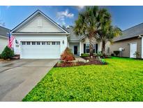 Charming one-story home with attached garage and manicured lawn at 575 Eastern Isle Ave, Summerville, SC 29486