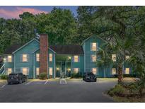 Evening view of a charming two-story light green building with ample parking at 6240 April Pine Cir # B, North Charleston, SC 29406