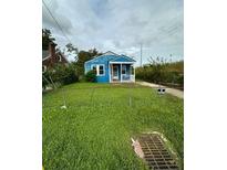 Charming blue house with a front porch and yard at 1806 Calvert St, North Charleston, SC 29405