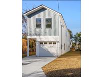 Two-story house with gray and white siding, attached garage, and a well-manicured lawn at 1994 Groveland Ave, North Charleston, SC 29405