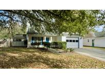 Charming one-story house with a garage and manicured lawn at 201 Regent St, Summerville, SC 29483