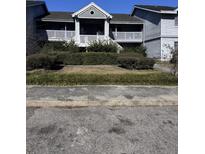 Two-story condo building with a well-maintained lawn and landscaping at 2507 Hidden Cove Dr # 2607, Moncks Corner, SC 29461