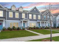 Two-story townhouses with gray siding, light-colored trim, and landscaping at 264 Godwit Dr, Summerville, SC 29486