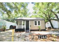 Charming renovated bungalow with a front porch and landscaped yard at 2744 E Surrey Dr, North Charleston, SC 29405