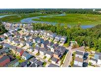 Aerial view of charming waterfront neighborhood with colorful houses at 3010 Evening Tide Dr, Hanahan, SC 29410