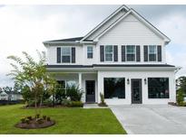 Two-story white house with gray shutters, landscaping, and a driveway at 778 Opal Wing St, Moncks Corner, SC 29461