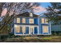 Two-story blue house with white accents, front porch, and landscaping at 118 Red Leaf Blvd, Moncks Corner, SC 29461